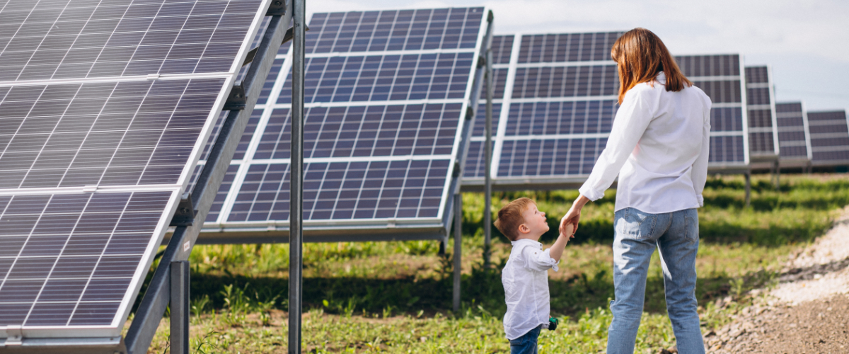 Mother with her little son by solar panels
